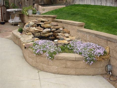 Block Retaining Wall A Raised Planter Bed And A Waterfall Built Into The Planter Diy Garden