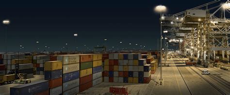 Stock Photo Night View Of Shipping Containers And Cranes At Port Of