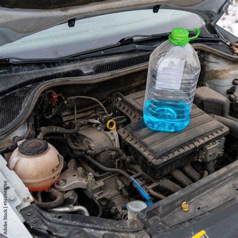 Blue Anti Freeze Windshield Washer Fluid Is On The Engine To Fill In