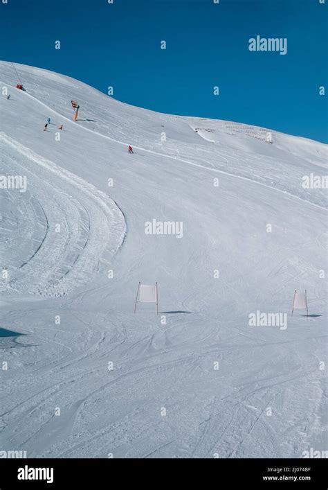 Vertical View Of Skiers Skiing Down Slopes In The Ski Resort Of Livigno