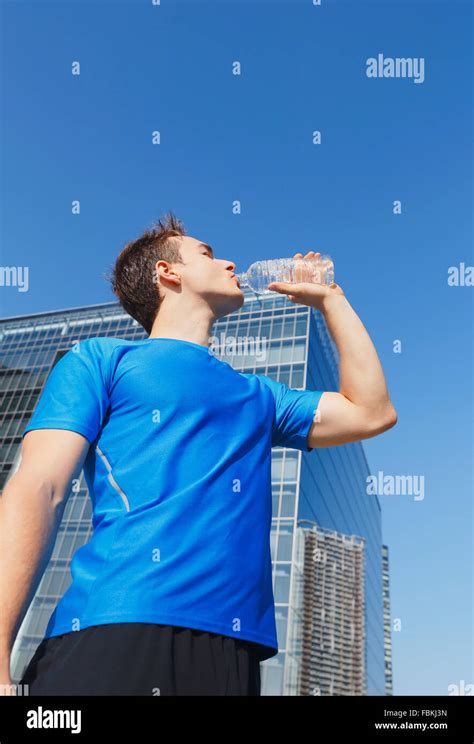 Young Caucasian Man Drinking Water In Metropolitan Area Stock Photo Alamy