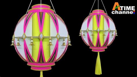 Two Colorful Lanterns With Tassels Hanging From The Sides One In Pink