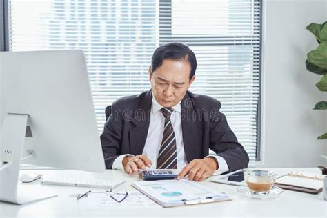 Middle Aged Asian Businessman Feeling Stressed And Frustrated While