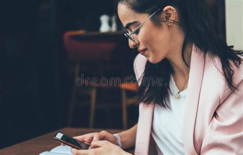 Calm Ethnic Lady Watching Smartphone Relaxing In Cafe Stock Photo