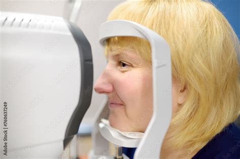 Portrait Of Mature Woman During Visit To Optometrist For Microscopic