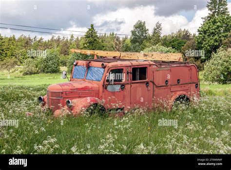 A Red Old Fire Engine Stands Abandoned In A Meadow Stock Photo Alamy