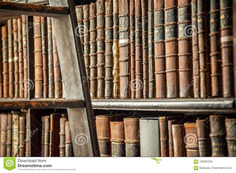 Old Vintage Books On Wooden Bookshelf And Ladder In A Library Editorial