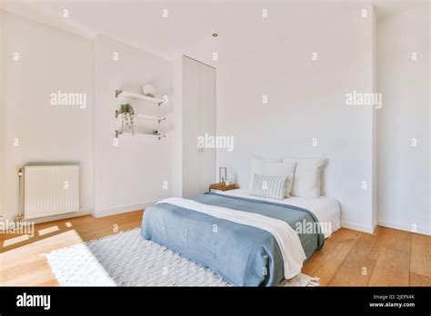 Home Interior Design Of Bedroom With Bed And Wooden Wardrobe Placed In