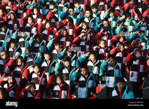 Young Chinese Students Wave Chinese National Flags During The Flag