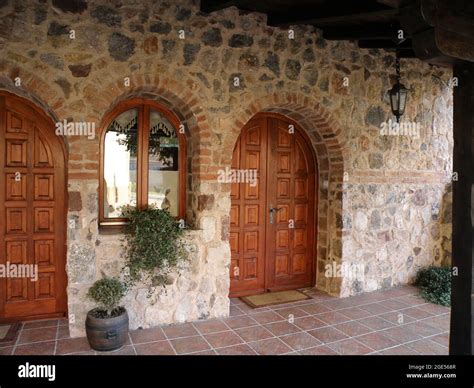 Rustic Stone House Terrace with Wooden Door Stock Photo - Alamy