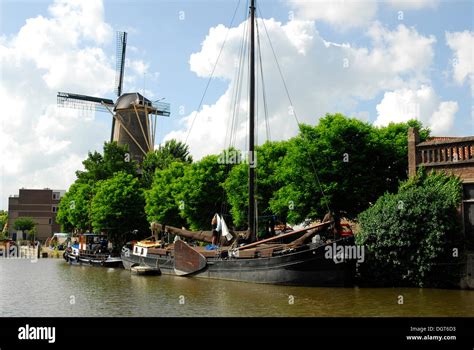 Windmill And Traditional Sailing Ship In The Harbor Binnenhaven Gouda