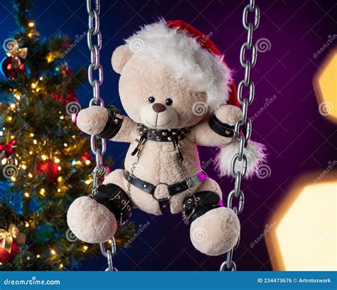 A Teddy Bear In A Santa Claus Hat Is A Christmas T For Bdsm Games On