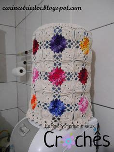 There Is A Crocheted Blanket On Top Of The Toilet