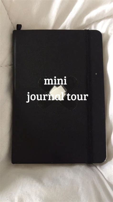 A Black Notebook With The Words Mini Journal Tour Written In White Ink