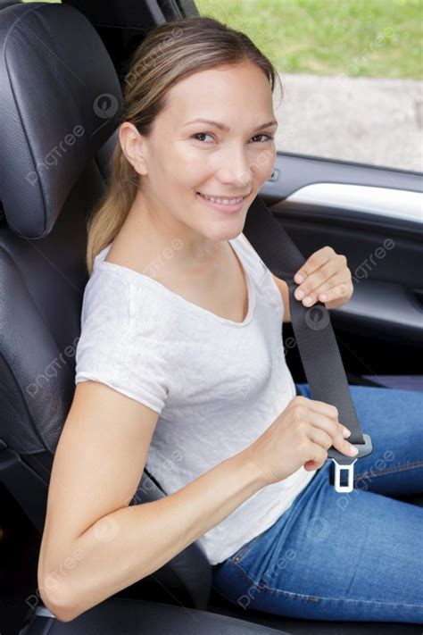 Portrait Of Attractive Young Woman Fastening Her Seatbelt Photo