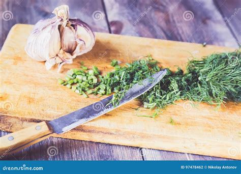 Fresh Green Dill Cut On The Kitchen Cutting Board With A Knife And