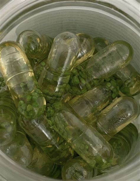 A Bucket Filled With Lots Of Green Peas And Bottles Next To Each Other