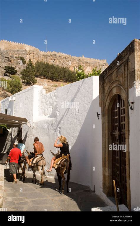 Tourists Riding On Donkeys To Acropolis Lindos Rhodes Greece Stock