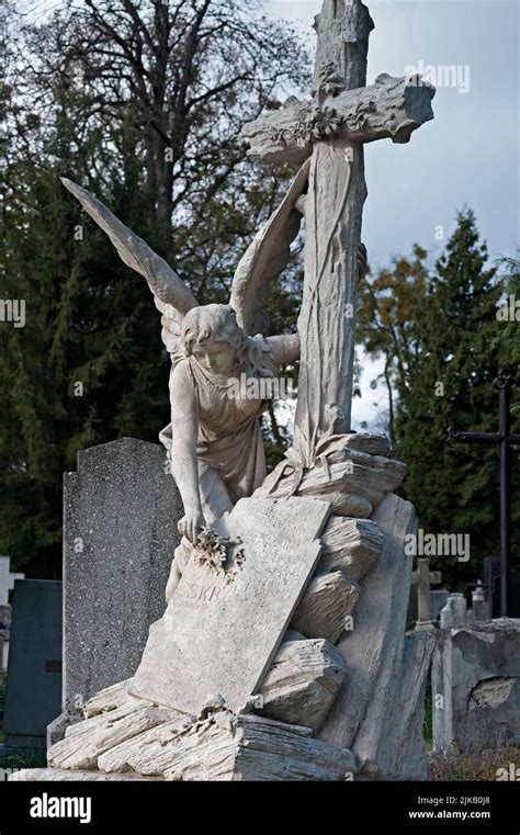 Tomb Sculpture Of An Angel Putting Flower On A Gravestone At Lychakiv