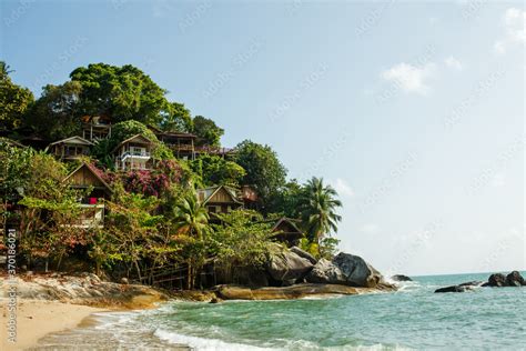 Tropical beach in Thailand with beach houses, blue ocean, white sand ...