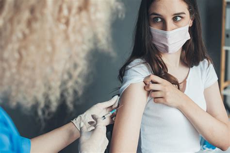 Doctor Giving Injection To Adult Woman At Hospital For Medical Design