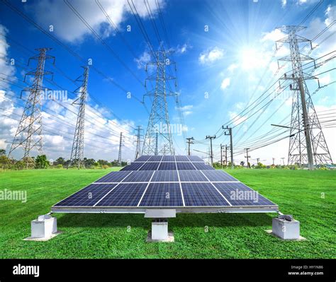 Solar Energy Panels And High Voltage Electricity Pylon Against Sunny