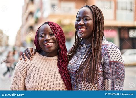 African American Women Friends Smiling Confident Hugging Each Other At