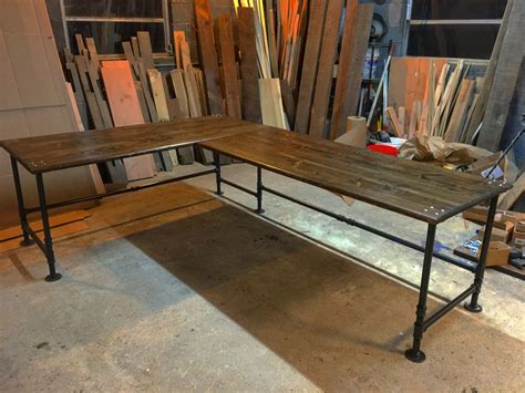 A Table That Is Sitting In The Middle Of A Room With Wood Boards On It