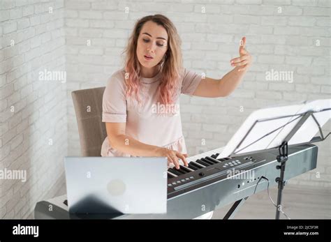 Remote music lessons. A singing teacher records the lesson on a laptop ...