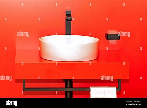 White Ceramic Sink Inside Bathroom Interior With Red Tiles Background