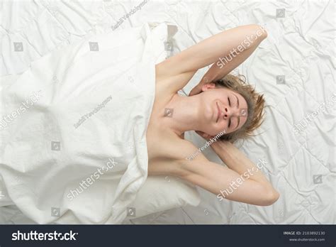 Стоковая фотография 2103892130 Beautiful Naked Woman Lies Bed Hands