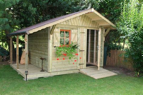 A Small Wooden Shed Sitting On Top Of A Lush Green Field