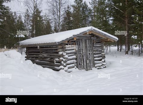 Typical Finnish Log Cabin In The Forest In The Snow Luosto Lapland