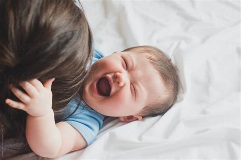 "Baby Laughing With Mom" by Stocksy Contributor "Lauren Lee" - Stocksy