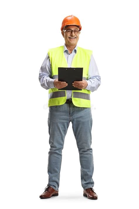 Full Length Portrait Of A Smiling Mature Male Engineer Holding A