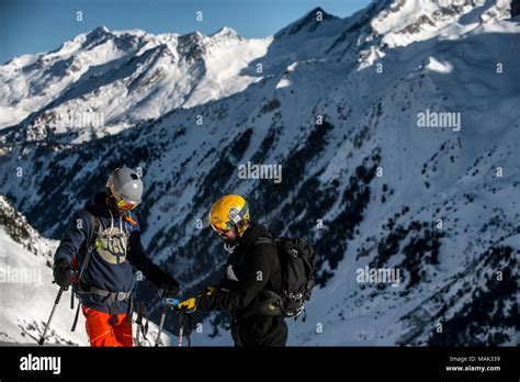 A Group Of Skiers Check Their Avalanche Transceivers Before Skiing Off