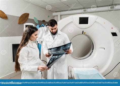 Colleague Doctors Discussing X Rays In The CT Computed Tomography Scan