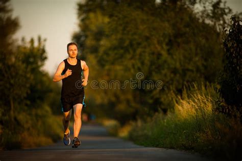 Shot Of A Young Male Athlete Training On A Race Track Stock Photo