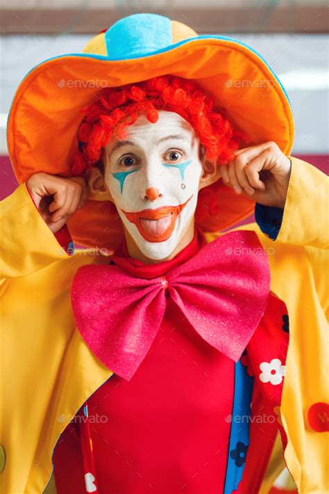 Funny clown dressed in colorful hat and costume Stock Photo by NomadSoul1