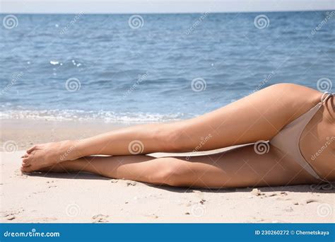 Woman With Perfect Body In Bikini Lying On Sandy Beach Near Sea