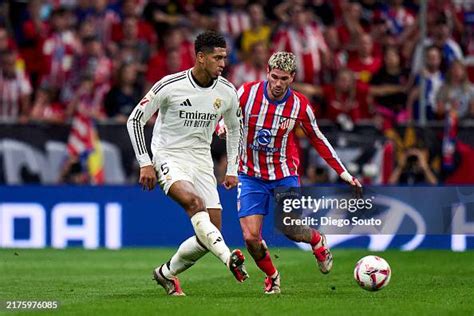 Rodrigo de Paul of Atletico de Madrid battle for the ball with Jude ...