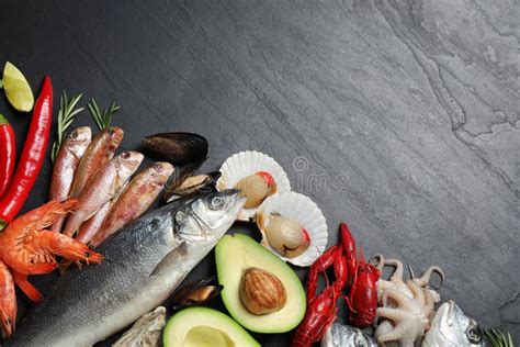 Fresh Fish And Different Seafood On Black Table Space For Text Stock