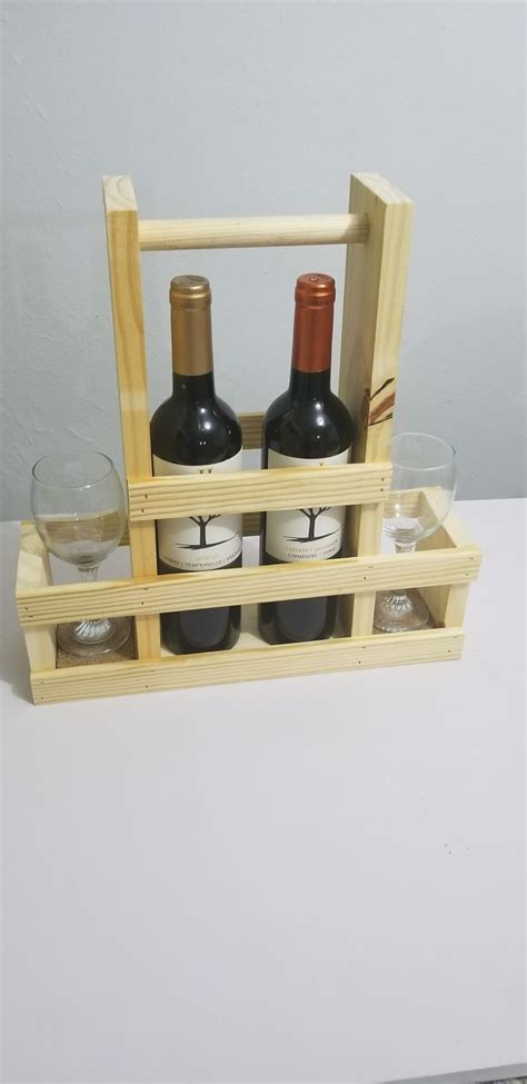 Three Bottles And Two Glasses In A Wooden Holder