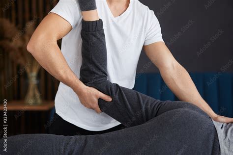 Female Patient Doing Physical Exercises With Physiotherapist Male