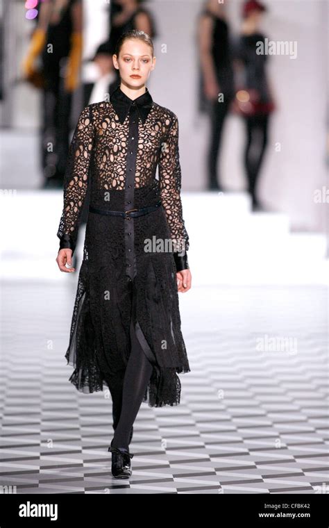 Model Kinga Rajzak Brunette Hair Off Face Wearing Black Open Work Lace Dress Solid Underskirt