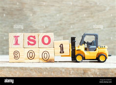 Toy Forklift Hold Letter Block To Complete Word Iso On Wood