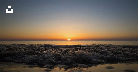 Black rocks on beach during sunset photo – Free Nature Image on Unsplash