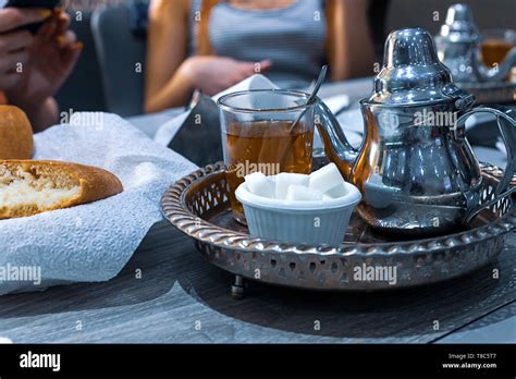 Moroccan Tea With Mint And Sugar In A Glasses On A Copper Plate With