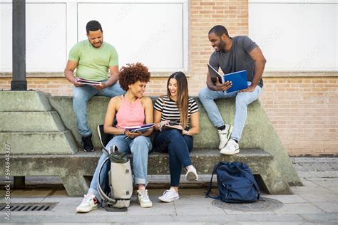 College Students Sitting On Bench