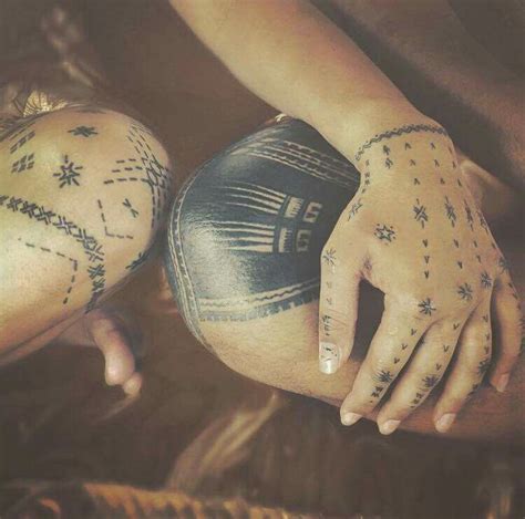 Two People With Tattoos On Their Arms And Hands